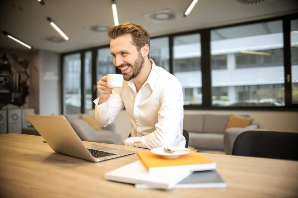 man drinking coffee while he automates review replies